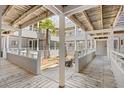 Condo courtyard featuring a wooden walkway, with a dining area and lush tropical plants at 351 Lake Arrowhead Rd. # 4-114, Myrtle Beach, SC 29572