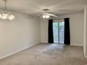 Living room featuring a ceiling fan and sliding glass door leading to a balcony at 3677 Clay Pond Village Ln. # 6, Myrtle Beach, SC 29579