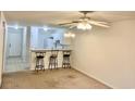 Living room featuring a ceiling fan, bar top with stools, and an open concept to the kitchen at 3677 Clay Pond Village Ln. # 6, Myrtle Beach, SC 29579