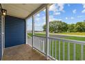 Inviting covered front porch with white railings and wooden flooring offers a relaxing outdoor space at 3759 Green Sea Rd., Green Sea, SC 29545