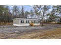 Exterior of a charming single story home with wooden porch and dark shutters at 3768 Green Sea Rd., Green Sea, SC 29545