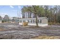 Exterior of a charming single story home with wooden porch and dark shutters at 3768 Green Sea Rd., Green Sea, SC 29545