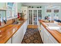 Charming kitchen featuring wooden countertops, white cabinets, and stainless steel appliances at 3926 Flagg St., Murrells Inlet, SC 29576