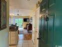 Inviting condo entryway with tiled floor and views to kitchen, living room, and outdoor porch at 398 Blue Stem Dr. # 59E, Pawleys Island, SC 29585