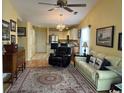 Comfortable living room with a cream-colored sofa, ceiling fan, and adjacent to a modern kitchen at 398 Blue Stem Dr. # 59E, Pawleys Island, SC 29585