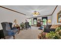 Spacious living room with neutral carpet, a fan, and plenty of space for seating and relaxation at 412 Carolina Dr., Loris, SC 29569