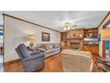 Inviting living room featuring a brick fireplace, hardwood floors, and cozy seating arrangements at 412 Carolina Dr., Loris, SC 29569