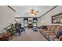 Cozy living room with carpeted floors, traditional furnishings, and natural light streaming through the windows at 412 Carolina Dr., Loris, SC 29569
