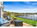 A patio with seating overlooks a serene lake view, complete with a decorative black metal fence at 455 Hyacinth Loop, Murrells Inlet, SC 29576