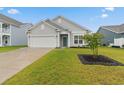Well-maintained single-story home with a green lawn and a two-car garage at 5031 Vinesia Dr., Myrtle Beach, SC 29579
