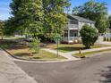 Corner lot features a gray home with double porches and manicured landscaping at 505 Beaty St., Conway, SC 29526