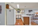 Bright kitchen with wooden cabinets, white appliances, and a breakfast bar overlooking the living area at 510 Fairwood Lakes Dr. # 923G, Myrtle Beach, SC 29588