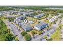 An aerial view of the condo community featuring a swimming pool, landscaping, and ample parking at 600 Heathrow Dr. # 1084, Myrtle Beach, SC 29579