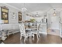 A charming dining area featuring a round table, elegant chairs, and stylish decor, adjacent to the kitchen at 600 Heathrow Dr. # 1084, Myrtle Beach, SC 29579
