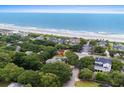 Aerial view showcases the property's proximity to the beach and surrounding lush landscape at 6401 N Ocean Blvd., Myrtle Beach, SC 29572