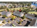 Aerial view of condo buildings overlooking a golf course, a lake and other homes in a well-maintained community at 703 Riverwalk Dr. # 303, Myrtle Beach, SC 29579