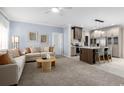 Open concept living space showcasing a spacious living room and a modern kitchen with island seating at 8204 S Highway 905, Longs, SC 29568