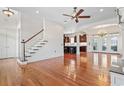 Open-concept living area featuring hardwood floors, a staircase, and view to the kitchen at 853 Bluffview Dr., Myrtle Beach, SC 29579
