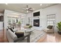 Cozy living room with hardwood floors, fireplace, ceiling fan, and comfortable seating at 853 Bluffview Dr., Myrtle Beach, SC 29579