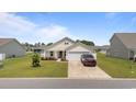 Attractive single-story home boasts a manicured lawn, attached garage, and welcoming curb appeal at 905 Sewing Bee Pl., Little River, SC 29566