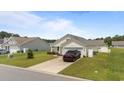 Inviting single-level home features a tidy lawn, neutral siding, and an attached garage at 905 Sewing Bee Pl., Little River, SC 29566