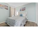 Bright bedroom featuring aqua walls, beach-themed decor, and a comfortable bed with patterned bedding at 920 N Waccamaw Dr. # 1302, Garden City Beach, SC 29576