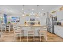 Well-lit kitchen with stainless steel appliances, granite countertops, and eat-in breakfast bar at 933 Wild Leaf Loop, Conway, SC 29526