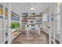 Bright office space with built-in bookshelves, hardwood floors, and natural light at 933 Wild Leaf Loop, Conway, SC 29526