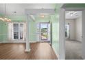 Inviting entryway featuring hardwood floors, white columns, and ample natural light at 1009 Hopscotch Ln., Conway, SC 29526
