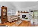 Cozy living room featuring a white brick fireplace, hardwood floors, and comfortable seating at 103 Robin Ct., Murrells Inlet, SC 29576