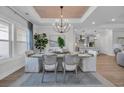 Bright dining area featuring a chandelier, wooden ceiling detail, and an open floor plan at 126 Westfield Circle, Conway, SC 29526