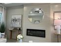 Cozy living room featuring shiplap walls, electric fireplace, and stylish decor at 126 Westfield Circle, Conway, SC 29526