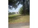 A partially obstructed view of the waterway and boat storage facility, located across the grassy lawn at 1313 Waterway Dr., North Myrtle Beach, SC 29582
