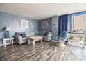 Comfortable living room featuring a sectional sofa, accent chair, and light blue painted walls at 1425 S Ocean Blvd. # 2A, North Myrtle Beach, SC 29582