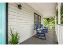 Inviting front porch with rocking chairs, offering a relaxing outdoor space with a peaceful ambiance at 1936 Lees Landing Circle, Conway, SC 29526