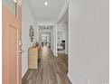 Welcoming entryway showcasing hardwood floors and a decorative console table with mirror at 205 Longside Ct., Little River, SC 29566