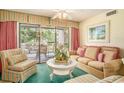 Inviting living room with comfortable seating, a glass coffee table, and access to the outdoor deck at 213 Westleton Dr. # 16B, Myrtle Beach, SC 29572