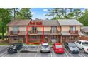 View of unit 218 featuring a charming balcony and well-manicured landscaping in a townhome complex at 218 Waccamaw Village Dr. # 218, Myrtle Beach, SC 29579
