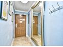 Hallway with mirror, tiled floor, and artwork at 2310 N Ocean Blvd. # 1107, Myrtle Beach, SC 29577