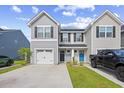 Charming townhome with gray siding, black shutters, white garage, and inviting black and blue front doors at 238 Christiana Ln. # C, Myrtle Beach, SC 29579
