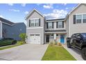 Charming townhome with gray siding, black shutters, white garage, and inviting black and blue front doors at 238 Christiana Ln. # C, Myrtle Beach, SC 29579