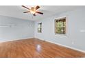 Bright bedroom with two windows, hardwood floors, and a ceiling fan at 238 Stonebrook Dr., Myrtle Beach, SC 29588