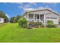 Well-manicured lawn and landscaping surround this cozy home with a welcoming front porch at 263 Walden Lake Rd., Conway, SC 29526