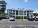 Exterior view of a three-story building with parking and private balconies at 330 S Middleton Dr. # 603, Calabash, NC 28467