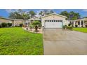 Charming one-story home with a well-manicured lawn and a driveway leading to an attached garage at 356 Lakeside Crossing Dr., Conway, SC 29526