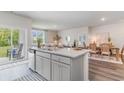 Open-concept kitchen with an island and seating, connecting to dining and living areas at 3583 Ashridge Way, Conway, SC 29526