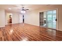 This open-concept living space has wood flooring, a ceiling fan, and sliding glass doors leading to an outdoor area at 3904 Williamson Circle, Myrtle Beach, SC 29579