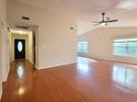 This spacious living room features gleaming hardwood floors, neutral paint, and plenty of natural light from large windows at 3904 Williamson Circle, Myrtle Beach, SC 29579