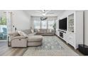 Spacious living room with a large sectional sofa, TV, and a ceiling fan at 4206 Falls Oaks St., Myrtle Beach, SC 29579