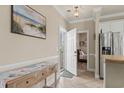 Inviting entryway with a decorative table, beach-themed artwork, and tile flooring at 4890 Luster Leaf Circle # 201, Myrtle Beach, SC 29577